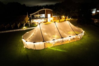 sailcloth marquee lit up at night